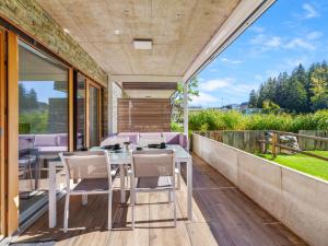 a patio with a table and chairs on a balcony at Apartment Central Parc 2 by Interhome in Crans-Montana