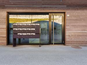 a glass door of a building with a window at Apartment Central Parc 2 by Interhome in Crans-Montana