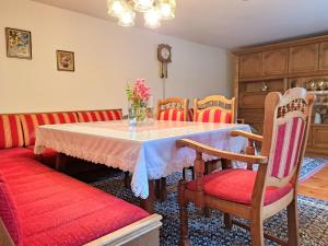 a dining room with a table and chairs at Holiday Home Lindnerhof by Interhome in Helpfau-Uttendorf +28 photos