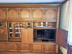 a large wooden cabinet with a television in it at Holiday Home Lindnerhof by Interhome in Helpfau-Uttendorf