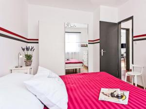 a bedroom with a bed with a pink blanket at Apartment Junior Suite-7 by Interhome in Ascona