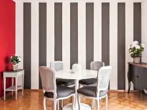 a dining room with a white table and chairs at Apartment Junior Suite-7 by Interhome in Ascona