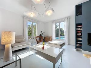 a living room with a table and a couch at Holiday Home Ma Petite Mer by Interhome in Le Clion-sur-Mer