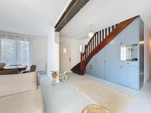 a living room with a sliding glass door and a staircase at Holiday Home Ma Petite Mer by Interhome in Le Clion-sur-Mer +26 photos