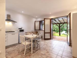 eine Küche und ein Esszimmer mit Tisch und Stühlen in der Unterkunft Holiday Home Villa 20 by Interhome in SantʼAmanza + 25 Fotos