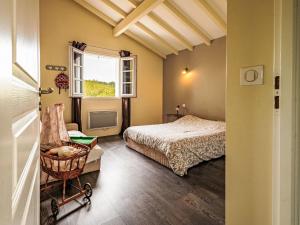 a bedroom with a bed and a chair and a window at Holiday Home OLHAKO BIDEA by Interhome in Amotz