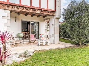 a patio with two chairs and a table at Holiday Home OLHAKO BIDEA by Interhome in Amotz