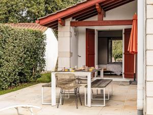 a white table and chairs on a patio at Holiday Home OLHAKO BIDEA by Interhome in Amotz