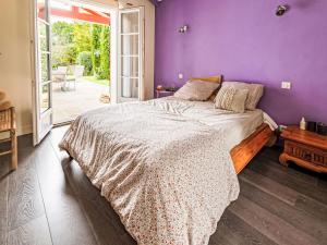 a bedroom with a bed with a purple wall at Holiday Home OLHAKO BIDEA by Interhome in Amotz +14 photos