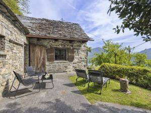 a group of chairs in front of a stone building at Holiday Home Rosa by Interhome in Agarone +11 photos