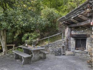 a stone table and bench in front of a building at Holiday Home Rosa by Interhome in Agarone