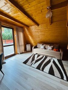 a bedroom with a bed in a wooden room at Casa Ursu in Cârțișoara