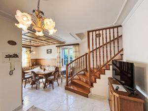 a living room with a staircase and a dining room at Holiday Home Großmutters Ferienhaus by Interhome in Mörbisch am See