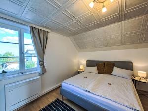 a bedroom with a bed and a window at Holiday Home Großmutters Ferienhaus by Interhome in Mörbisch am See