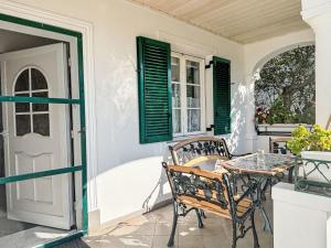 a patio with a table and chairs on a porch at Holiday Home Großmutters Ferienhaus by Interhome in Mörbisch am See +25 photos