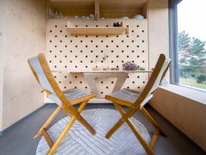 two chairs sitting next to a desk in a tiny house at Chalet Glamping Sokolka by Interhome in Branžež