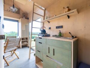 a kitchen with a green dresser in a room at Chalet Glamping Sokolka by Interhome in Branžež