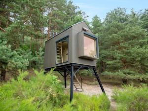 a tiny house on a tripod in the woods at Chalet Glamping Sokolka by Interhome in Branžež