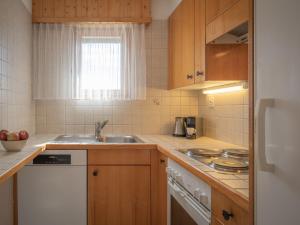 a small kitchen with a sink and a stove at Apartment Sources 4110 by Interhome in Ovronnaz