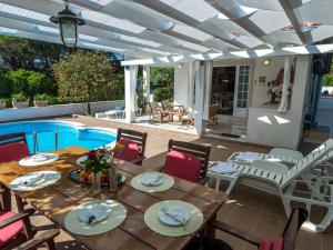 a patio with a table and chairs next to a pool at Holiday Home Maya by Interhome in Brgulje