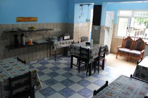 a kitchen with a table and chairs in a room at Pousada Paulista Santos in Santos