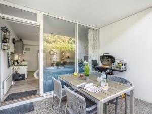 a dining room with a table and a large window at Apartment Lelle - 150m from the sea by Interhome in Søndervig