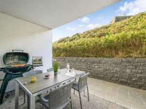 a patio with a grill and a table and chairs at Apartment Lelle - 150m from the sea by Interhome in Søndervig