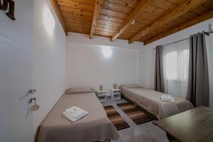 a room with two beds and a window at Casa Mario in La Giustiniana