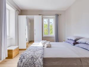 a bedroom with a large bed and a window at Holiday Home Ivanica by Interhome in Zablaće +22 photos