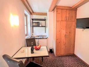 a small room with a table and a refrigerator at Apartment Cheeky Apartment-1 by Interhome in Oberndorf in Tirol