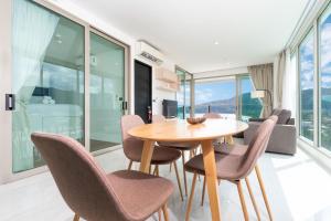 a dining room with a table and chairs at Elegant 2BR Oceanview Condo Oceana C73 - 5 min walk Kamala Beach in Kamala Beach