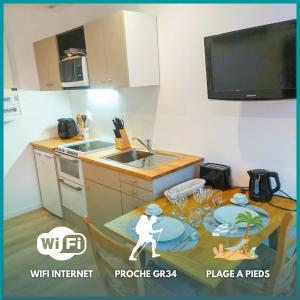 a kitchen with a table with a picture of a person on it at Ty Angel - wifi - 1er étage in Crozon