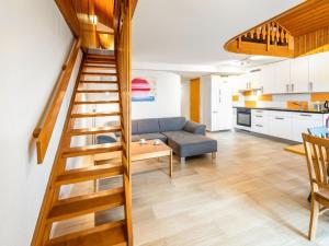 a staircase leading to a living room and kitchen at Apartment Centaure-4 by Interhome in Les Rasses +21 photos