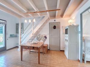 a kitchen with a table and a staircase in a room at Holiday Home Les Charmilles-16 by Interhome in La Palmyre +35 photos