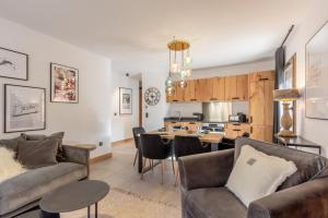 a living room with a couch and a table at Blanchets, Terrasse et confort 4 étoiles in Champagny-en-Vanoise +23 photos