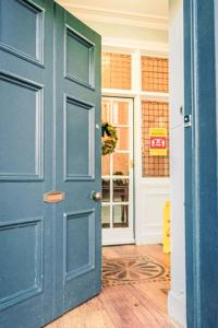 an open blue door in a room with a door at Studio Room 26 by Interhome in Nairn