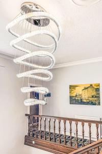 a large glass chandelier hanging from a ceiling at Studio Room 26 by Interhome in Nairn