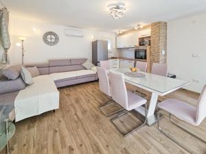 a living room with a couch and a table at Holiday Home Vinovac by Interhome in Kruševo