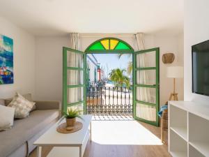 a living room with a couch and a window at Marina nº 296 in Puerto de Mogán
