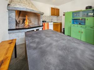 a kitchen with an oven with a table in front of it at Holiday Home Vinovac by Interhome in Kruševo +16 photos