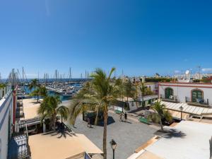 a view of a marina with palm trees and buildings at Marina nº 296 in Puerto de Mogán