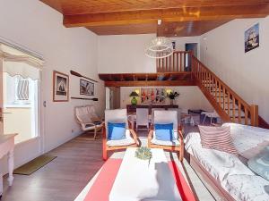 a living room with a couch and a staircase at Holiday Home Les Floriales by Interhome in Vaux-sur-Mer +33 photos