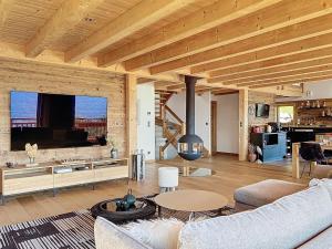 a living room with a couch and a table at Chalet Chalet ECO by Interhome in Thyez