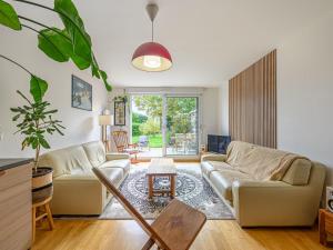 a living room with two couches and a table at Apartment Le nid du Golfe by Interhome in Mériadec