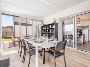 a dining room with a white table and chairs at Holiday Home Bol d'Air by Interhome in Ploubalay