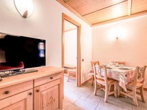 a dining room with a table and a television at Apartment Residence gli Scoiattoli-1 by Interhome in Madesimo +23 photos