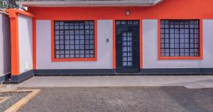 a red and white building with doors and windows at OFB Investment Homes in Bungoma