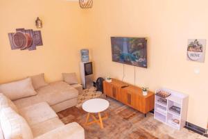 a living room with a couch and a tv at OFB Investment Homes in Bungoma