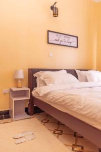 a bedroom with a bed and a sign on the wall at OFB Investment Homes in Bungoma