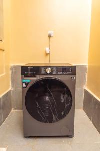 a washing machine sitting in the corner of a room at OFB Investment Homes in Bungoma